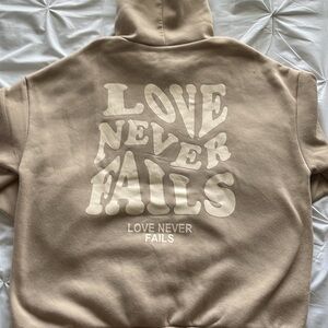 Shein hoodie, Large, Tan, says Love Never Fails